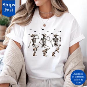 Cowboy Skeleton T-Shirt, Dancing Skeleton Halloween Tee Spooky Western Graphic T-Shirt with Bats, Funny Halloween Two-Stepping Costume Shirt