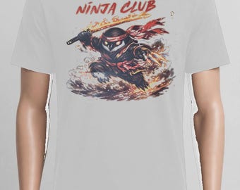 May include: A light gray short-sleeve t-shirt featuring a graphic print of an owl dressed as a ninja with a flaming sword and claws. The text "NINJA CLUB" is printed in red above the owl, which is surrounded by swirling smoke and fire effects.
