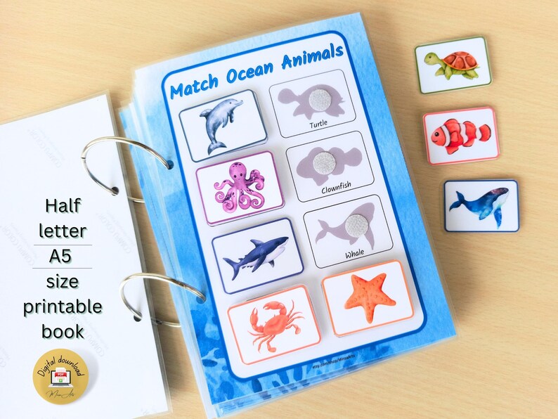 May include: A printable book with a blue background and images of ocean animals. The book has a title that says "Match Ocean Animals". The book includes images of a dolphin, turtle, octopus, clownfish, whale, crab, and starfish. There are also separate cards with images of the animals.