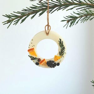 Scented hanging ornaments for tree and wardrobe, festive wax sachet decor handcrafted with natural ingredients.