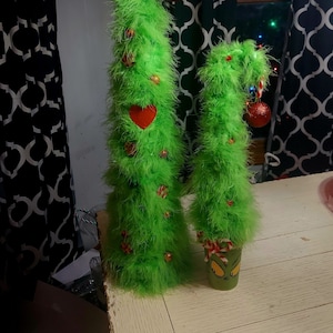 Adorable furry 18 inch Grinch themed bent christmas tree in a Grinch face Cup. Too cute