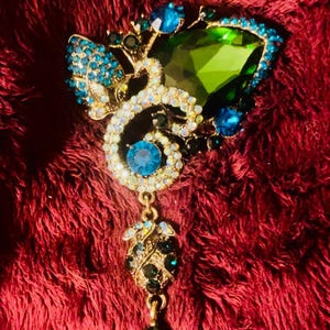 Heidi Daus Stunning blue green rhinestone dangle brooch