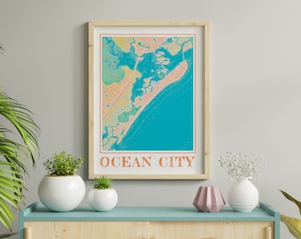May include: A framed print of a colorful map of Ocean City, Maryland. The map is in a light wood frame and is hanging on a light gray wall. There are plants and vases on a light blue and wood shelf below the print.