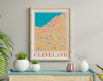 May include: A framed print of a map of Cleveland, Ohio. The map is in a retro style with a yellow, orange, and green color scheme. The city name is printed in red at the bottom of the map.