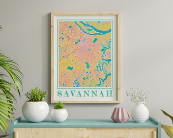 Könnte beinhalten: Ein gerahmter Druck einer farbenfrohen Karte von Savannah, Georgia. Die Karte ist in Rosa-, Gelb- und Blautönen gehalten. Das Wort "SAVANNAH" ist unten auf dem Druck in Grün gedruckt.