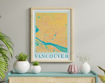 May include: A framed print of a map of Vancouver, Canada. The map is in a yellow and blue color scheme. The word "Vancouver" is printed in blue at the bottom of the map.
