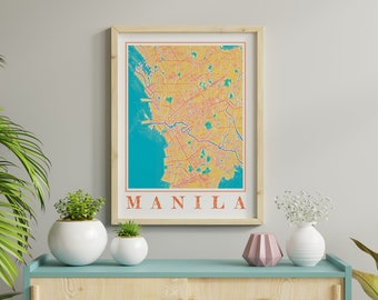 May include: A framed print of a map of Manila, Philippines. The map is in a vintage style with a yellow background and red lines. The word "MANILA" is printed in orange at the bottom of the map.