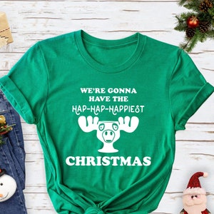 May include: Green t-shirt with a white moose graphic and the text "We're gonna have the hap-hap-happiest Christmas".