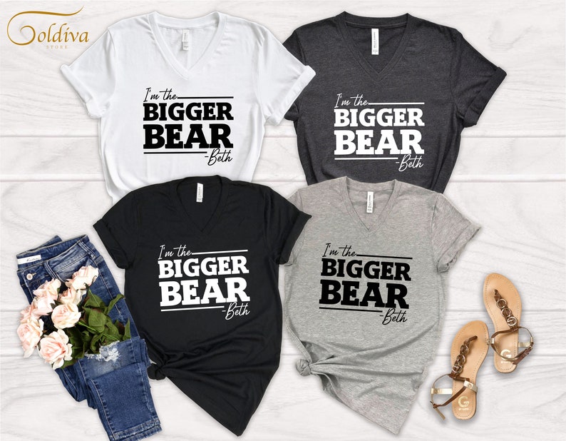 May include: Four V-neck t-shirts with the text "I'm the BIGGER BEAR -Beth" printed in black on white, black, heather gray, and dark gray shirts.
