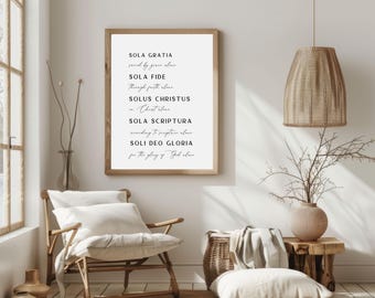May include: A framed print with the text "Sola Gratia", "Sola Fide", "Solus Christus", "Sola Scriptura", and "Soli Deo Gloria" in a white frame.