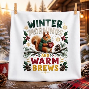 May include: A white square towel featuring a graphic of a brown squirrel wearing a green scarf and holding a red mug. The text reads WINTER MORNINGS AND WARM BREWS, surrounded by illustrations of pine branches, pinecones, holly, and snowflakes.