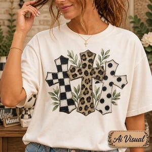 Digital sublimation instant download of A cream-colored short-sleeve t-shirt featuring a graphic print of three crosses. The left cross has a black and white checkered pattern, the center cross has a brown leopard print, and the right cross has a white and black polka dot pattern. PNG file transparent background.