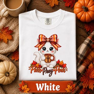 Fall Apparel Autumn Graphic Tee October Themed Clothing Halloween Shirt Kawaii Cat Design Cozy Casual Wear Unisex Fashion White Cat Illustration Striped Coquette Bow Detail Cat Lover Gift Perfect Present Garment Dyed Cotton Comfortable Daily Outfit Christian Women Youth Gift