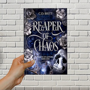 May include: Book cover with a skull and roses. The title is "Reaper of Chaos" with the subtitle "Blood of Saviors Book One" in a blue and black color scheme.