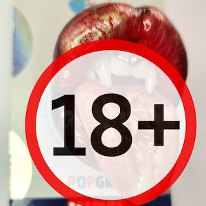 May include: A PopSockets phone grip with a red and gold mouth design and fangs. The packaging includes the PopSockets and Marvel logos, and an 18+ warning symbol.