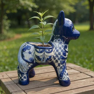 The Talavera Hub blue and white ceramic donkey planter with floral patterns. Handcrafted Mexican art.