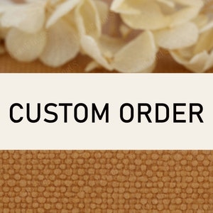 May include: A white sign with the text "CUSTOM ORDER" in black letters. The sign is on a brown textured background.