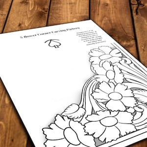 May include: Black and white line art pattern for leather carving. The pattern features five flowers with a flowing design. The title "5 flower corner carving pattern" is at the top of the page.