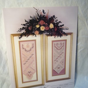 May include: Cross stitch pattern for a heart-themed design. The pattern is framed and shows two different designs, both with pink and white thread. The pattern is titled "Heart's Delight" and is from the "Cross 'n Patch" collection.