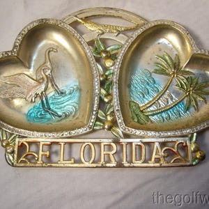 May include: A set of three ceramic mugs with a speckled, matte finish in cream, light brown, and dark brown. Each mug has a simple design and a rounded handle.