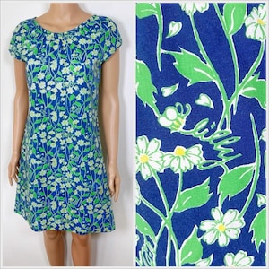 May include: A blue and green floral print short-sleeved dress with a scoop neck.