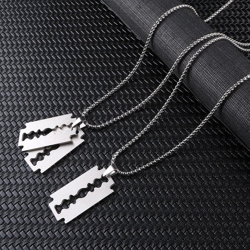 An “Addicted” silver razor blade necklace with diamonds
