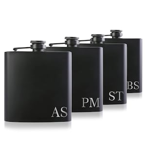 May include: Set of four black stainless steel hip flasks with engraved initials: AS, PM, ST, and BS.