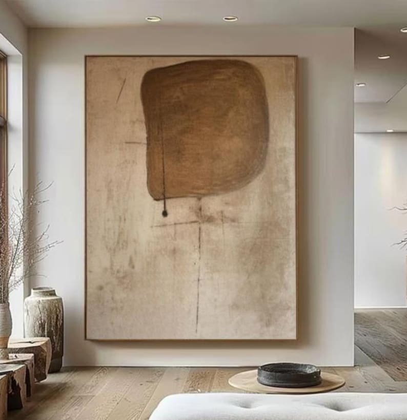 May include: Abstract art painting with a large brown shape on a beige background. The shape is irregular and has a rough texture. The background is textured and has a subtle pattern.