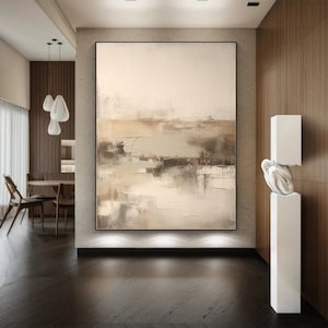 May include: Abstract painting in shades of beige, brown, and gray with a textured finish. The painting is hanging on a wall in a modern interior with wood paneling.