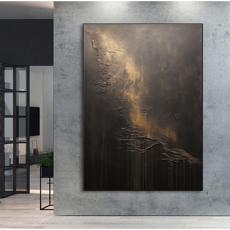 May include: Abstract painting with a textured, dark brown background and a golden, flowing design. The painting has a modern and minimalist style.