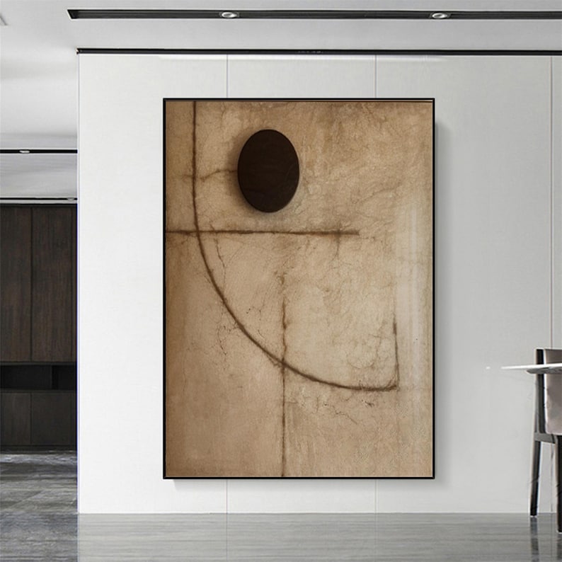 Puede incluir: Impresi&oacute;n de arte abstracto con un fondo marr&oacute;n y un c&iacute;rculo negro en el centro. La impresi&oacute;n presenta un dise&ntilde;o geom&eacute;trico con l&iacute;neas y curvas.