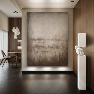 May include: A modern living room interior with a large abstract painting on the wall, a white sculpture on a pedestal, and a wooden dining table with chairs.
