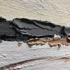 May include: Abstract painting with thick layers of textured paint in shades of white, gray, and brown. The painting has a horizontal composition with a thick band of gray paint at the top and a thin band of brown paint at the bottom.