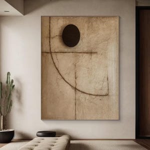 Puede incluir: Impresi&oacute;n de arte abstracto con un fondo marr&oacute;n y un c&iacute;rculo negro en el centro. La impresi&oacute;n presenta una l&iacute;nea marr&oacute;n que se curva alrededor del c&iacute;rculo y una l&iacute;nea horizontal que interseca el c&iacute;rculo.