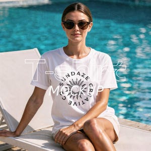 May include: A white t-shirt with the text "SUNDAZE CREATIVE MOCKUP" and a sun graphic. The model is wearing sunglasses and sitting on a white lounge chair near a pool. The shirt is a casual, everyday wear item.