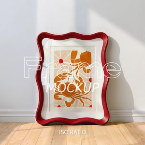 Puede incluir: Un marco rojo con bordes ondulados y un borde interior blanco, que muestra una impresión con una ilustración de cangrejo en naranja y blanco. La impresión está sobre un fondo melocotón claro con formas rojas en forma de sol. Las palabras "Frame Mockup" e "ISO RATIO" son visibles.