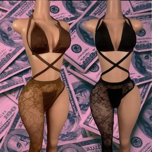 May include: Two lingerie sets on mannequins. One is brown with a halter top and crisscross straps, paired with a lace pantyhose. The other is black with a similar design. The background is a pink hue with dollar bills.