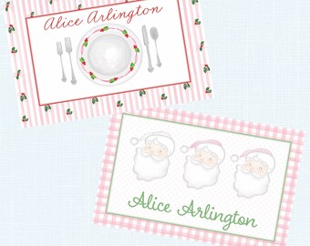 May include: Two Christmas-themed place cards. One features a plate setting with a red and white striped background. The other has three Santa faces and a pink gingham border. Both cards have the name "Alice Arlington".