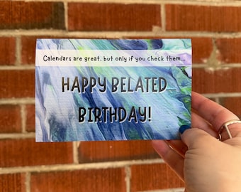 May include: A blue and green card with the text "Calendars are great, but only if you check them... Happy Belated Birthday!"