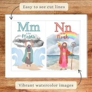 May include: Two watercolor illustrations with the letters "Mm" and "Nn". "Mm" is for Moses, depicted with a staff, and "Nn" is for Noah, with a rainbow. The text "Easy to see cut lines" and "Vibrant watercolor images" are also present.