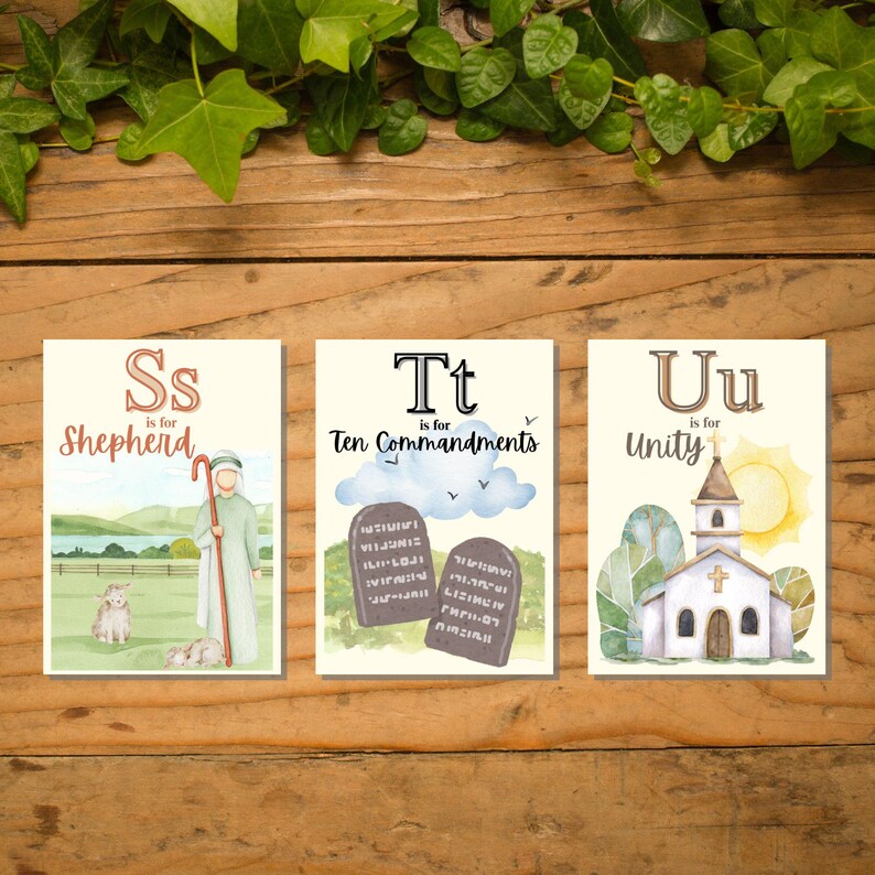 May include: Three illustrated cards with religious themes. The first card features a shepherd with a staff and sheep, labeled "S is for Shepherd." The second card shows the Ten Commandments, labeled "T is for Ten Commandments." The third card depicts a church, labeled "U is for Unity."