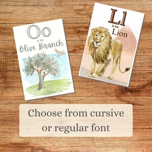 May include: Two watercolor alphabet art prints. One features the letter "O" with "Olive Branch" text and an olive tree illustration. The other shows the letter "L" with "Lion" text and a lion illustration. The text "Choose from cursive or regular font" is also present.