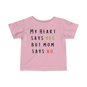 May include: Pink baby t-shirt with the text "My heart says yes but mom says no" in black with the words "yes" in green and "no" in red.