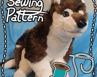 May include: A plush husky dog with brown and white fur, sitting on a blue surface. The image includes the text "Sewing Pattern" in a decorative frame, along with a spool of teal thread and a needle.