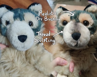 May include: Two plush wolf toys with dark gray and tan fur, black noses, and brown eyes. Text on the image points to features, reading Realistic Dry Brushing and Thread Sculpting, highlighting the detailed craftsmanship of the stuffed animals.