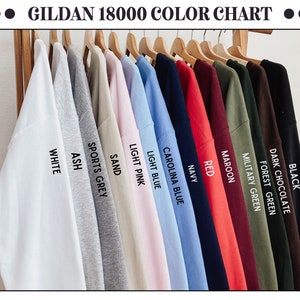 May include: A colour chart of Gildan 18000 sweatshirts, showing 12 different colours: black, dark chocolate, forest green, military green, maroon, red, navy, Carolina blue, light blue, light pink, sand, sports grey, ash, and white.