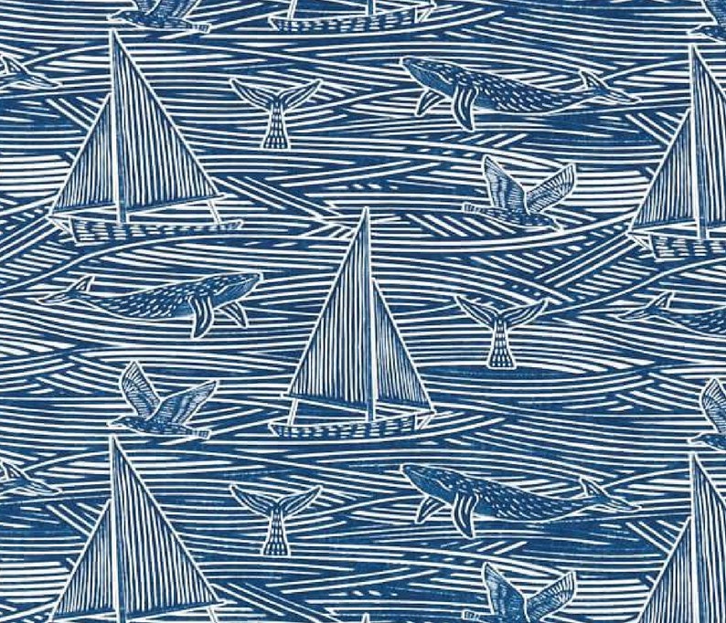 May include: A blue and white patterned fabric with a nautical theme. The pattern features sailboats, whales, seagulls, and waves. The fabric is perfect for quilting, sewing, and crafting.