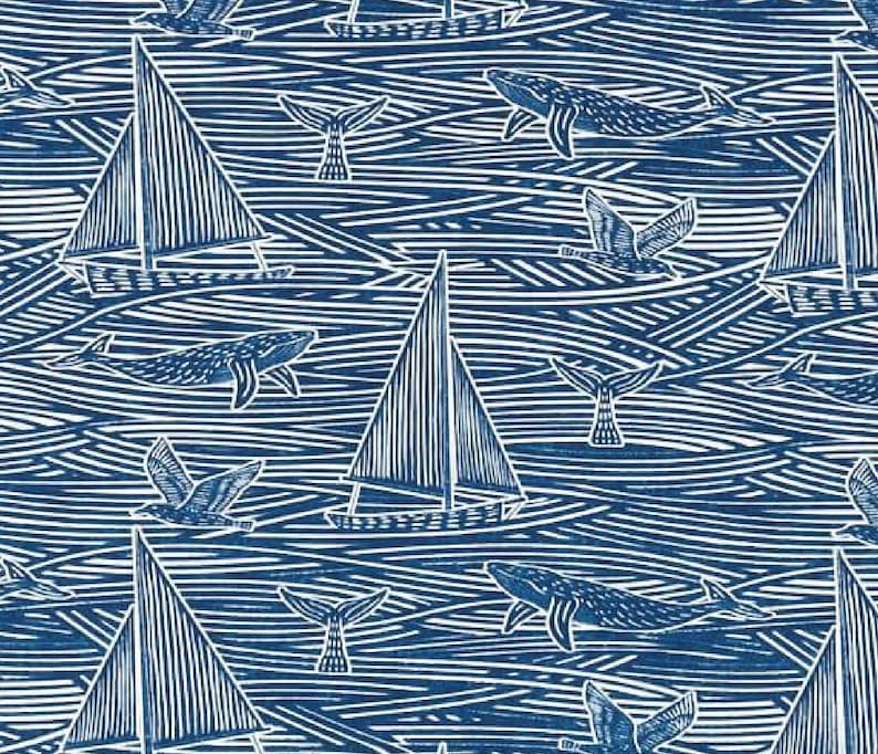 May include: A blue and white patterned fabric with a nautical theme. The pattern features sailboats, whales, seagulls, and waves. The fabric is perfect for quilting, sewing, and crafting.