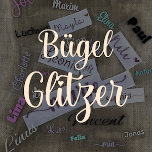 Könnte beinhalten: Eine Sammlung von Bügelbildern mit Namen in verschiedenen Farben und Schriftarten, darunter Jolina, Maxim, Finn, Ludwig, Mayla, Elina, Melina, Paul, Jeonie, Ninja, Lina, Pinus, Kira, Felix, Mia, Jonas und Sophia. Der Text "Bügel Glitzer" ist ebenfalls auf dem Bild zu sehen.