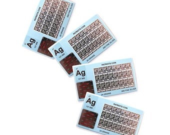 May include: Four silver coins with a Patriots logo and the chemical symbol for silver, Ag, with the atomic number 47 and atomic weight 107.508. Each coin has the words "Patriots Coin" and "24 Grains 999 Fine Silver".